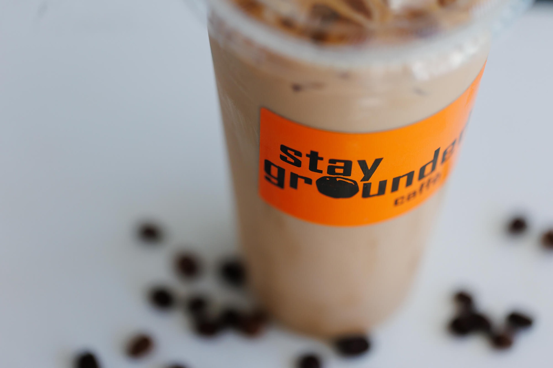 Iced coffee in a Stay Grounded to-go cup.